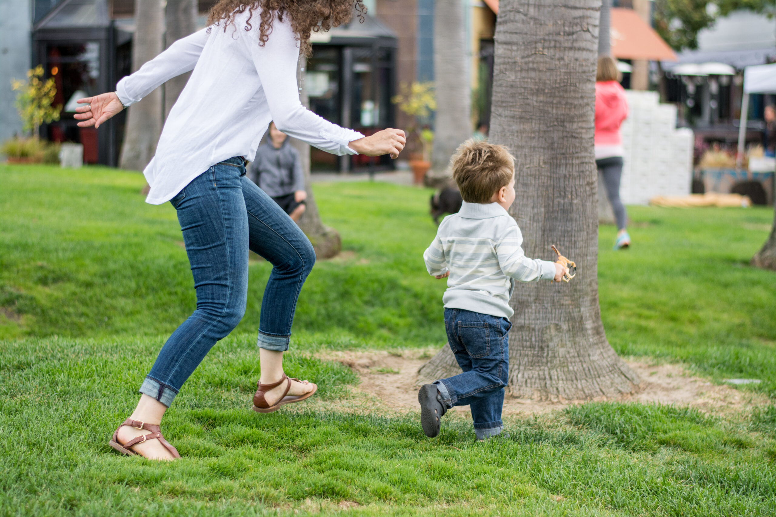 Dr. Jolene Brighten chasing her son in a park.